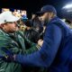 Michigan State football coach Jonathan Smith shakes Sherrone Moore's hand.