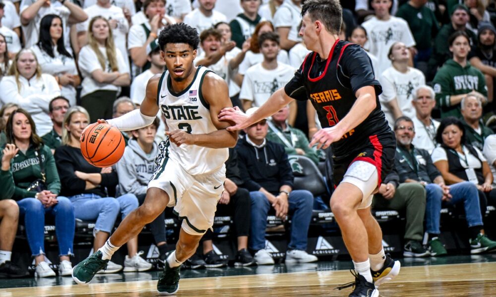 Michigan State basketball senior Jaden Akins drives the baseline.