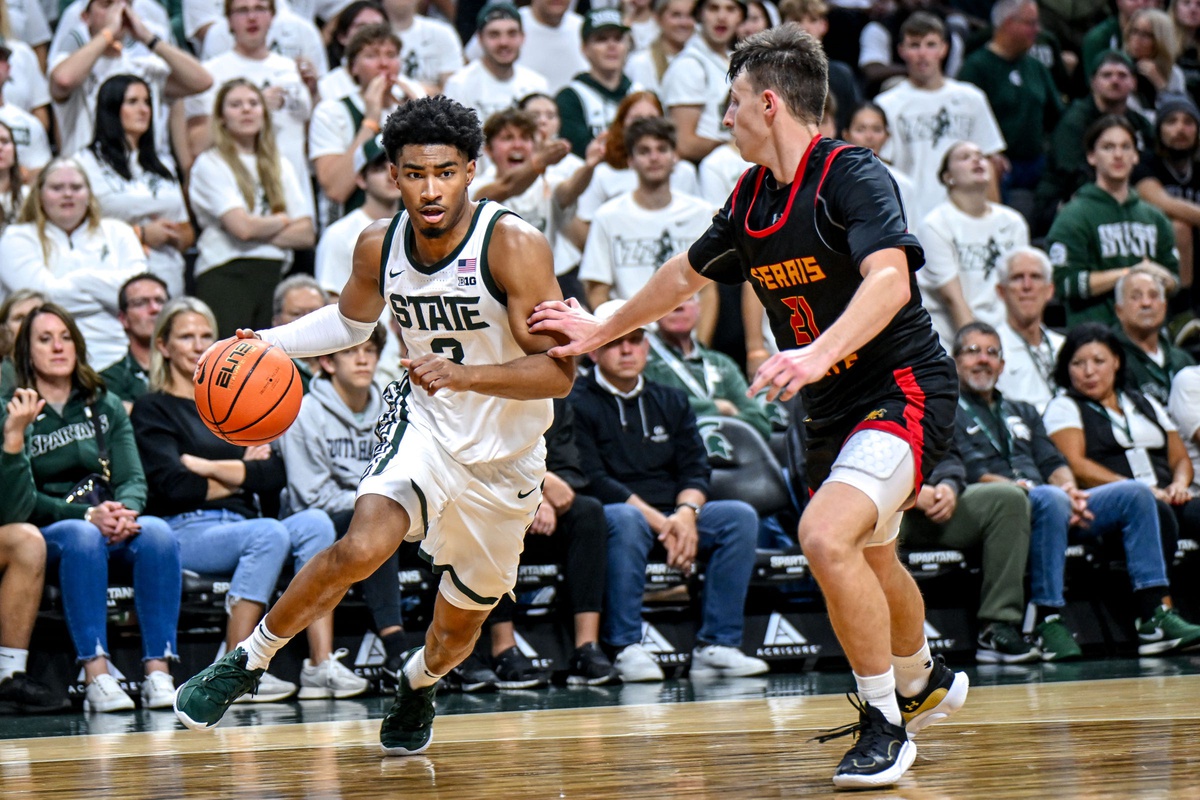 Michigan State basketball senior Jaden Akins drives the baseline.