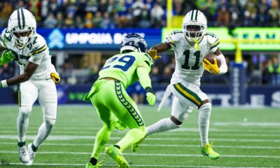 Former Michigan State football star Jayden Reed with runs the ball for the Packers against Seattle.