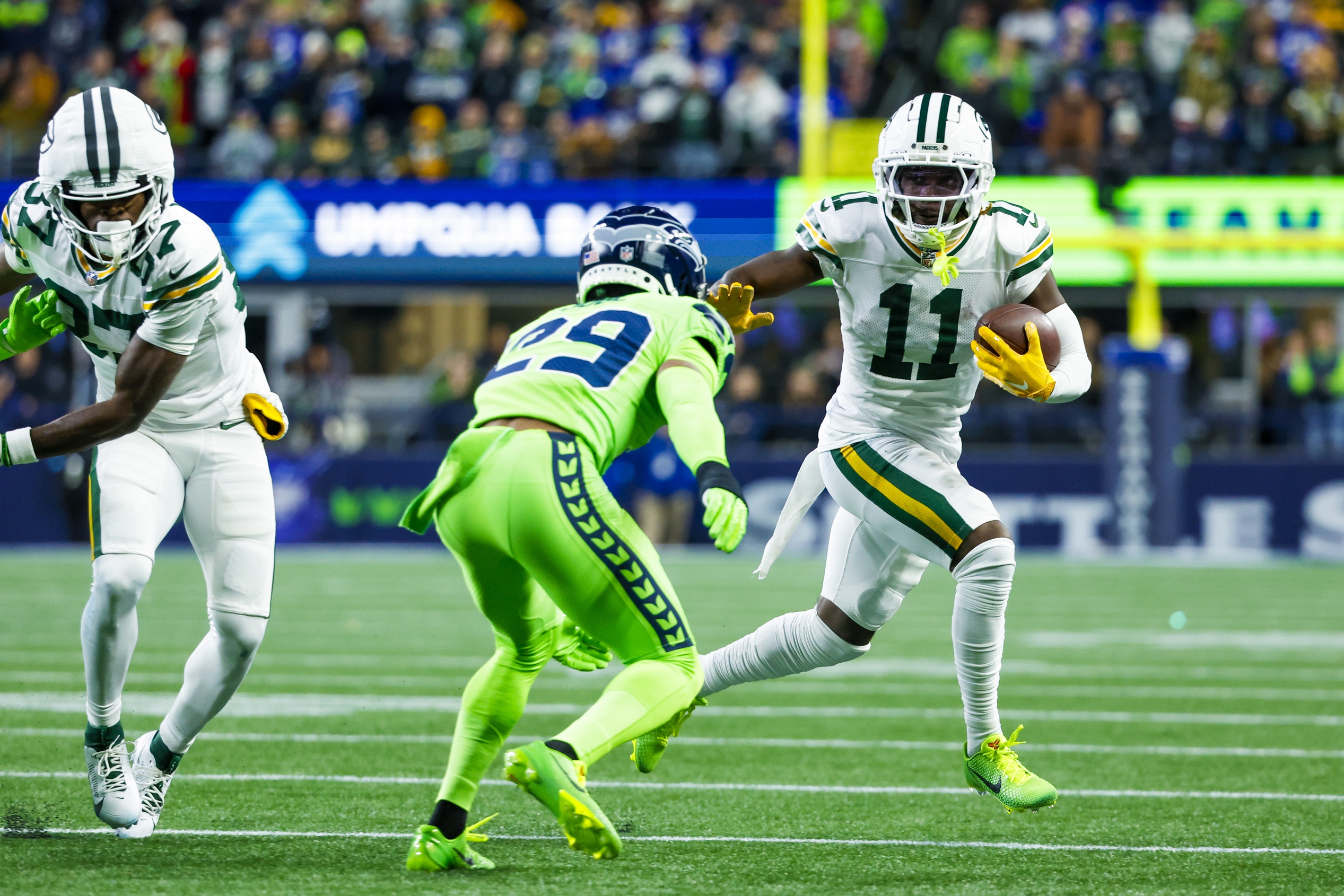 Former Michigan State football star Jayden Reed with runs the ball for the Packers against Seattle.