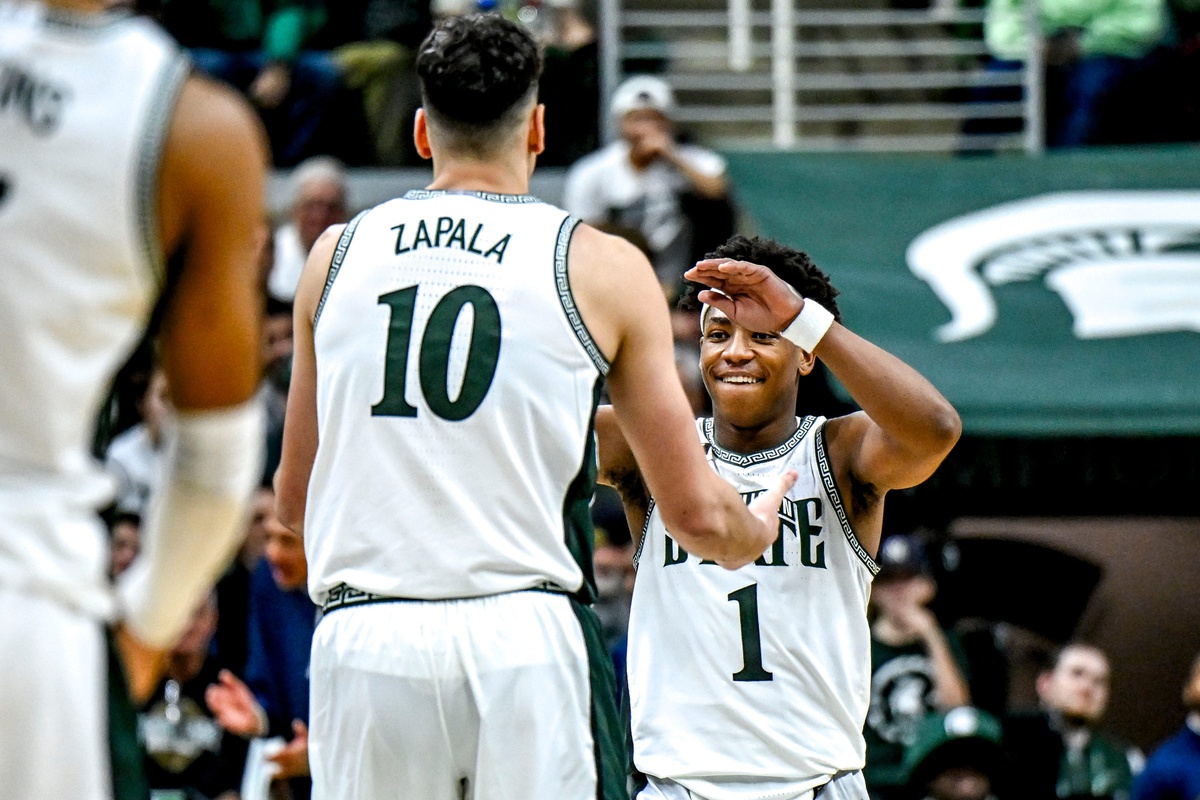 Michigan State basketball guard Jeremy Fears high-fives Szymon Zapala.