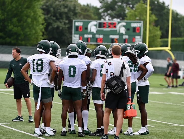Michigan State football huddles up at practice