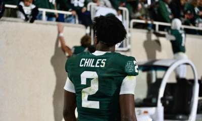 Michigan State football QB1 Aidan Chiles walks off the field.