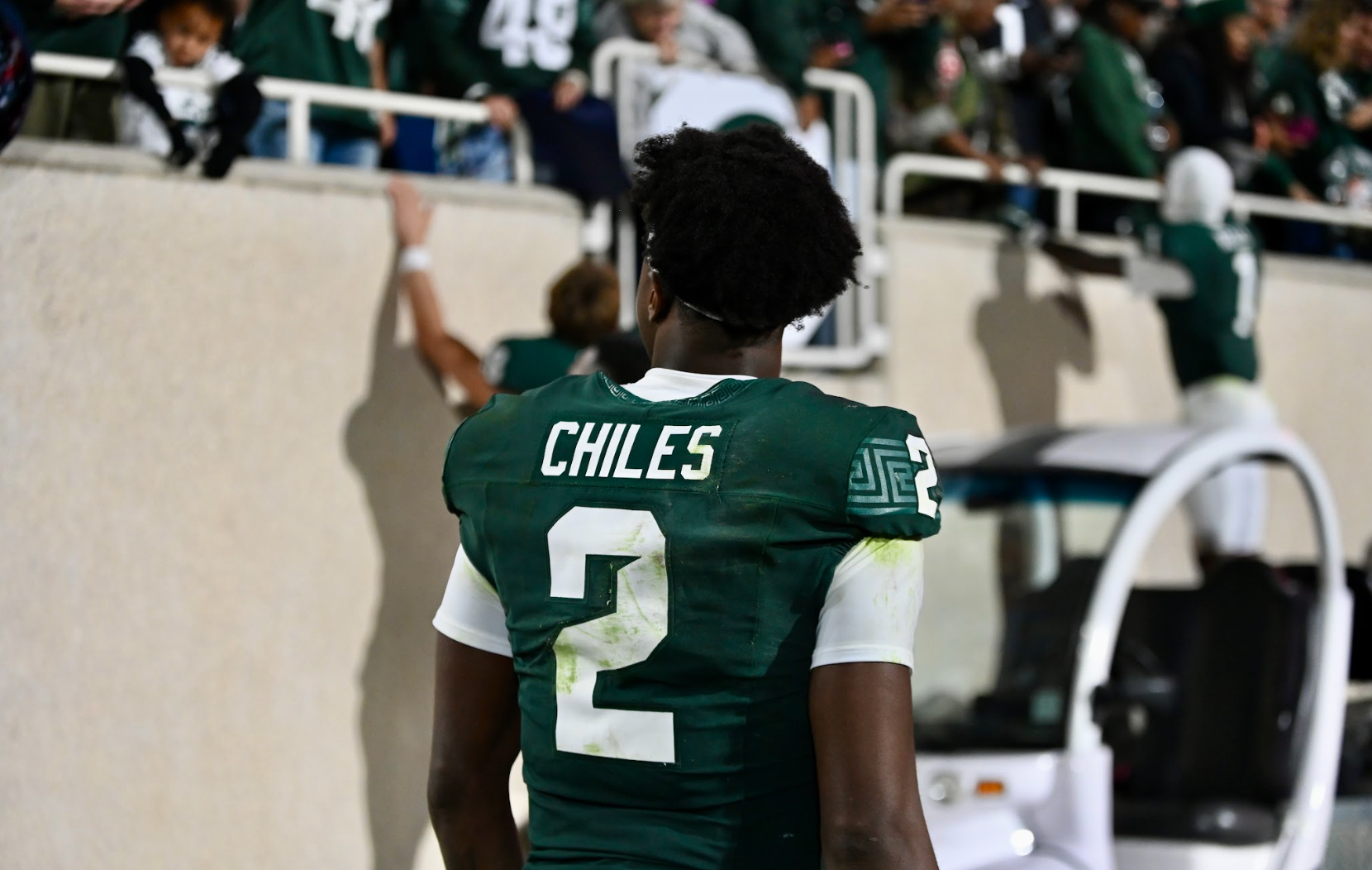 Michigan State football QB1 Aidan Chiles walks off the field.