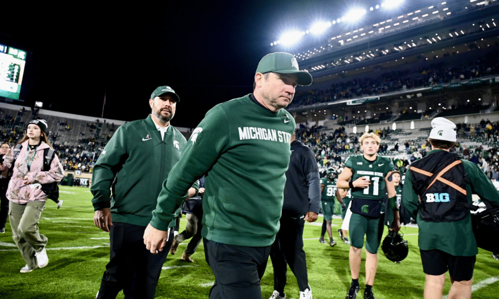 Michigan State football coach Jonathan Smith walks off the field after losing to Michigan