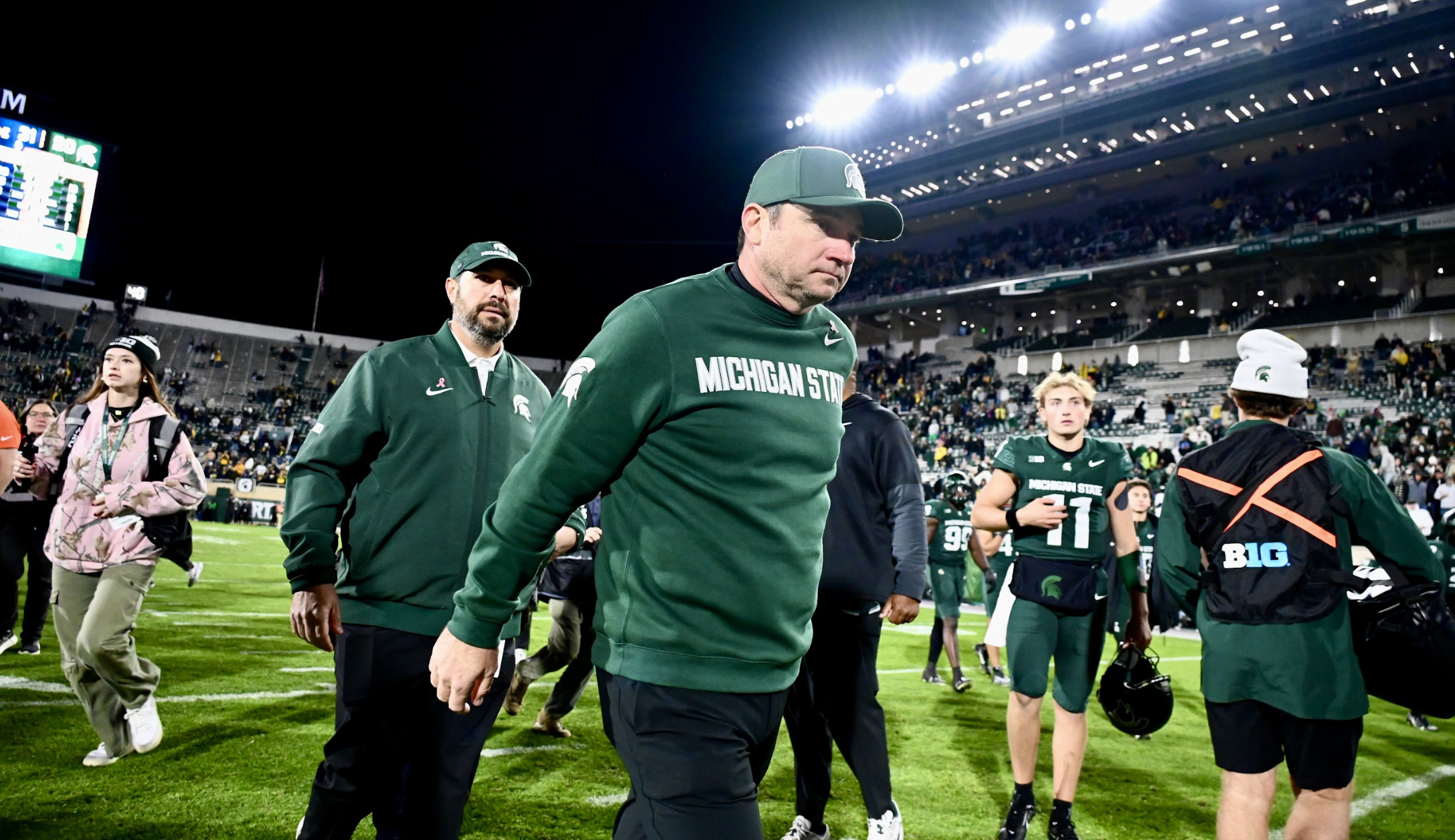 Michigan State football coach Jonathan Smith walks off the field after losing to Michigan
